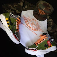 a pair of camouflage shoes and a camouflage t - shirt